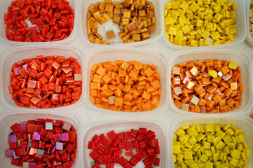 Containers with colored glass elements for mosaic. Yellow, red, orange. Creativity. art .