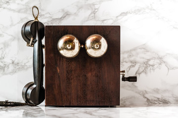Antique Magneto Hand Crank Telephone Set on Marble Background