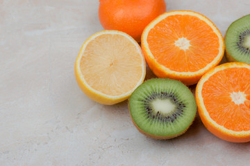  Female hands holding a lemon, orange, kiwi on a white background