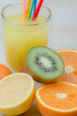  Female hands holding a lemon, orange, kiwi on a white background