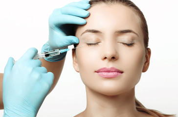 Woman getting cosmetic injection of botox in cheek, closeup - 220790213