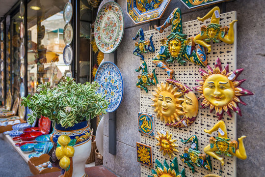 TAORMINA, ITALY - OCTOBER 16, 2014: Typical Sicilian Souvenir in ceramic symbolising the sunshine and triskelions - symbol of Sicily