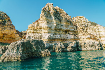Fototapeta na wymiar Rocks, Cliffs And Ocean Landscape At Lagos Bay Coast In Algarve, Portugal