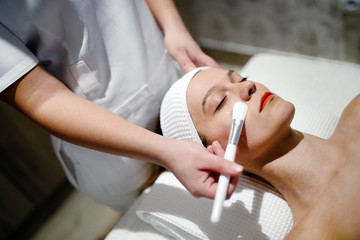 Masseur applying face mask