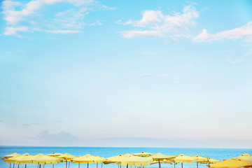Beach with yellow umbrellas. Landscape of the sea 
