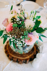 Obraz na płótnie Canvas Wedding table flower decoration. Glass vase with table number.