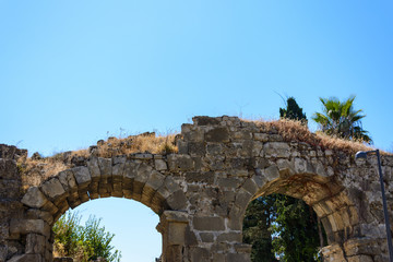 antique stone arched bridge with two spans. Side, Turkey