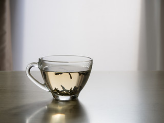 Glass tea placed on the table by the window.