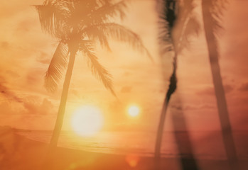 Retro style background on which there is sunset on the beach with palm trees. It's beautiful colourful. There are orange, red and yellow sun rays.