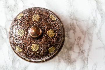 Handcrafted Cupper Service Desk Bell on Marble Background