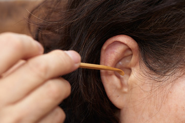 cleaning ear using wooden earpick