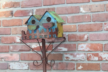 Bird House against brick 