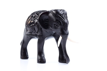 Black Engraved pattern gold elephant made of resin like wooden carving with white ivory. Stand on white background, Isolated, Art Model Thai Crafts, For decoration Like in the spa. 