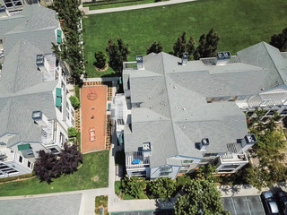 Aerial view typical multi-level apartment homes with playground in Cupertino, Silicon Valley,...