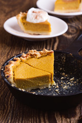 Slices of pumpkin pie in cast iron skillet