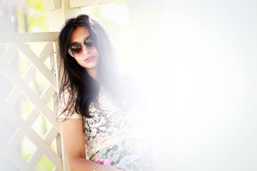beautiful young women near a fence