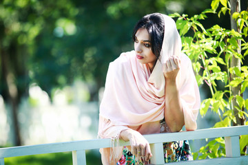 Naklejka premium beautiful young women near a fence