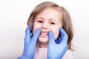 Dental medicine and healthcare - dentist examining little child girl patient open mouth showing...