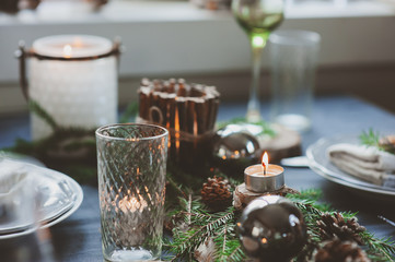 Festive Christmas and New Year table setting in scandinavian style with rustic handmade details in...