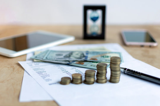 Hourglass and currency. Time is money concept.