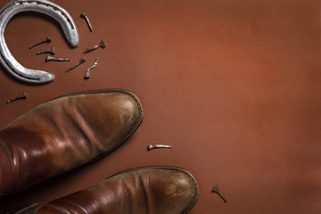 Horseshoe, nails, and a pair of leather shoes