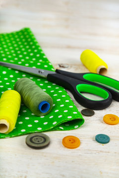 Sewing accessories and green fabric