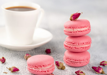 Pink macaroons on a vintage plate and dried flower buds. Pastel colored