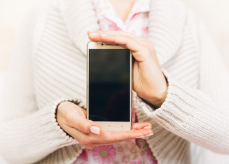 woman with phone in her hands.mock up with black screen.focus on phone