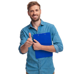 young student holding a clipboard makes the ok sign