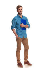 smiling young casual student holding clipboard