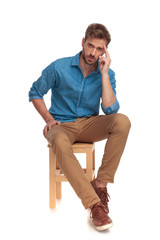 seated casual man focusing on something