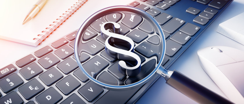 Dunkle Tastatur mit Lupe und Paragraph