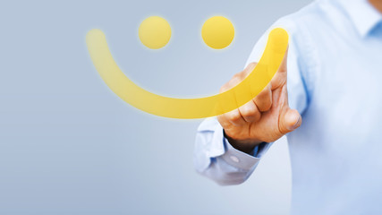 Hand of client show a feedback with smiley face card. Service rating, satisfaction concept