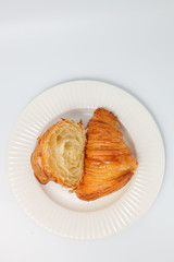 Freshly baked traditional croissant cut into two parts