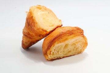 Freshly baked traditional croissant cut into two parts