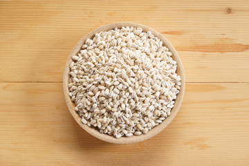 Barley rice on wooden background