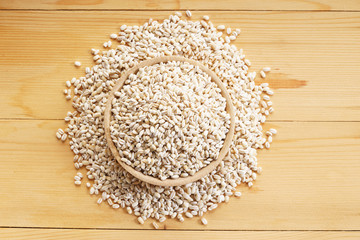 Barley rice on wooden background