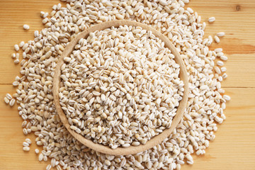 Barley rice on wooden background