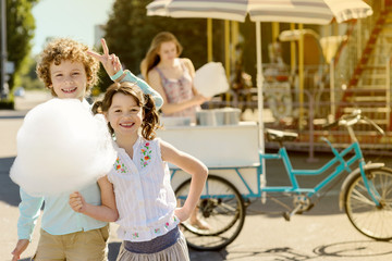 Fototapeta na wymiar Pleased children with cotton candy