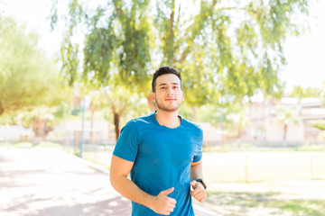 Ambitious Runner Working Out In Park During Summer