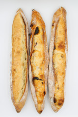 Three fresh French baguettes on white background