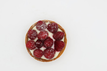 Tartlet with raspberry on white background
