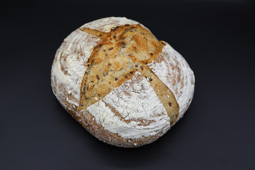 Fresh bread with seasonings on a dark background