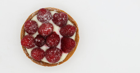 Tartlet with raspberry on white background