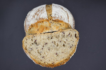 Cut in half bread with seasonings on a dark background