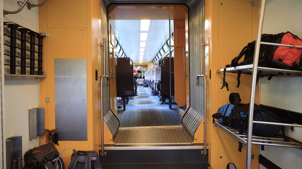 Luggage and Backpacks inside train storage rack