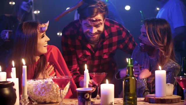 Man in costume scaring his friends at halloween party