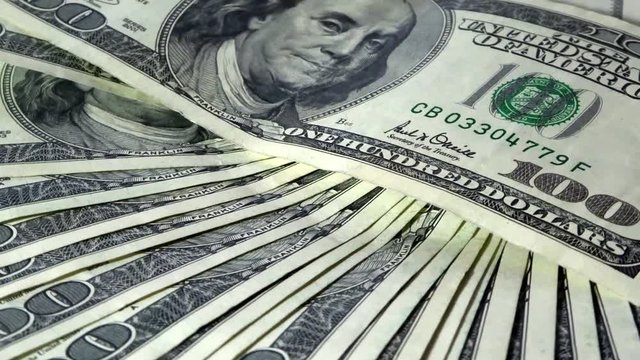 Bunch of 100 dollar bills in motion