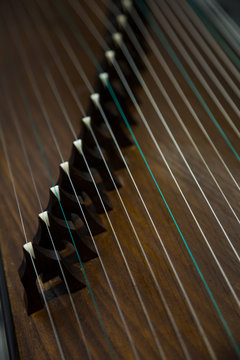 Gu Zheng. The Zheng is a traditional Chinese musical instrument. It&ensp;belongs&ensp;to&ensp;the&ensp;zither&ensp;family&ensp;of&ensp;string&ensp;instruments.&ensp;