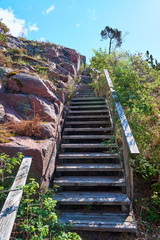 Fototapeta na wymiar Wooden stairs between rocks.